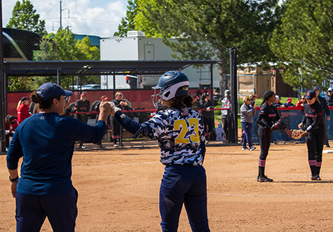 Deena and coach fist bumping during game