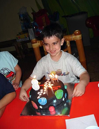 Young Bretton with space themed birthday cake